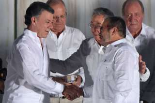 Colombian President Juan Manuel Santos and the Farc leader known as Timochenko shake hands in ceremony in Cartagena in September